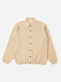 The Sand Eco Cotton Knit Jacket is presented as a flat lay against a white background. The jacket features a full button front, a structured collar, and a large square patch pocket on the left chest. It is designed with a loose fit and finished with rib trims at the cuffs and hem.
