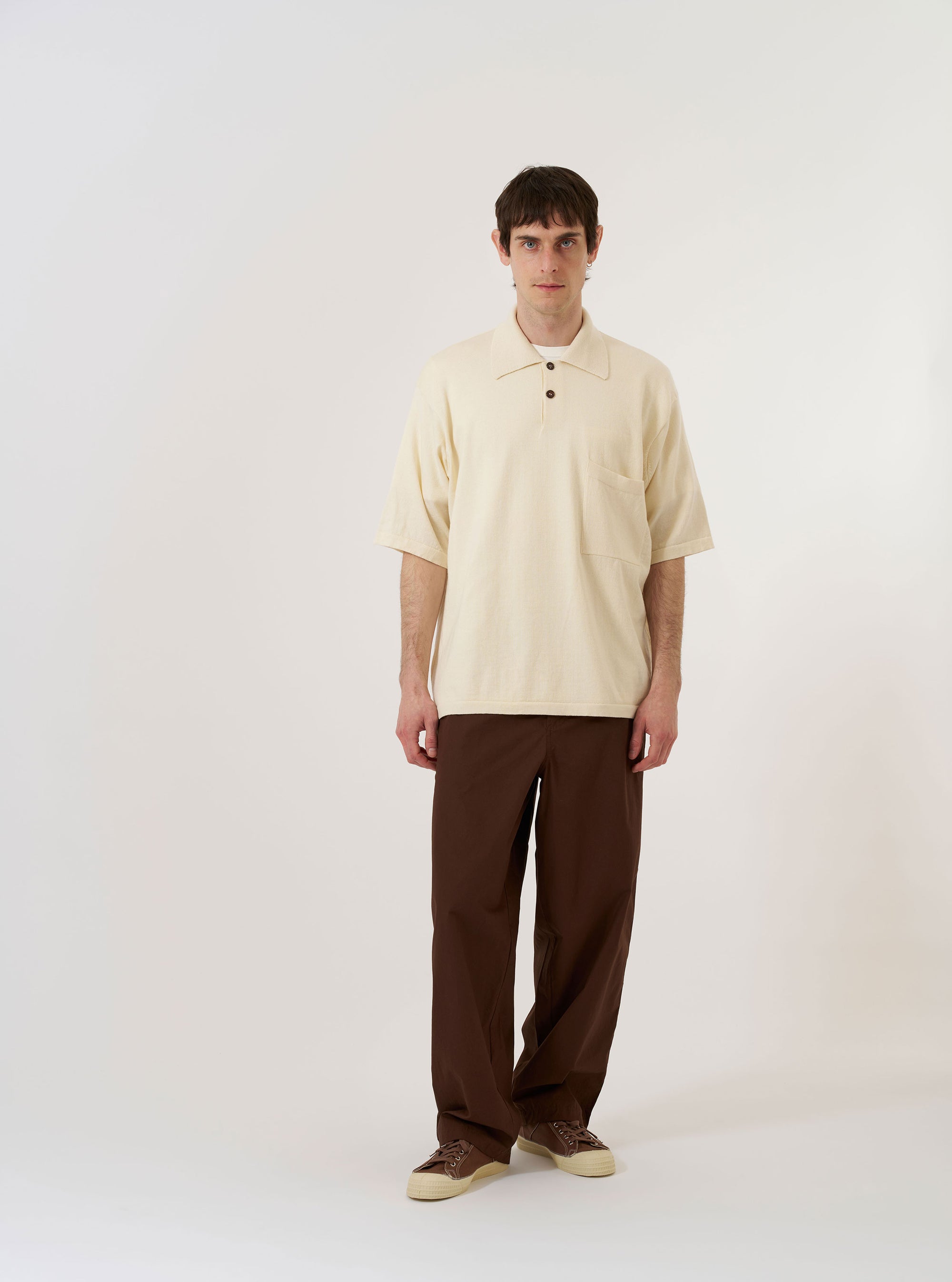 The Ecru Woolcot Bio S/S Pullover Knit Shirt II is shown as a flat lay against a plain white background. The shirt features short sleeves, a button placket with a large one-piece collar, and a single chest pocket on the left side. The ecru-colored fabric has a smooth, lightweight knit texture.