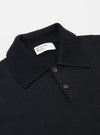 The Black Woolcot Bio S/S Pullover Knit Shirt II is shown from a rear angle as a flat lay against a plain white background. The image highlights the smooth, fine-gauge knit texture of the black fabric, the short sleeves, and the straight hem.