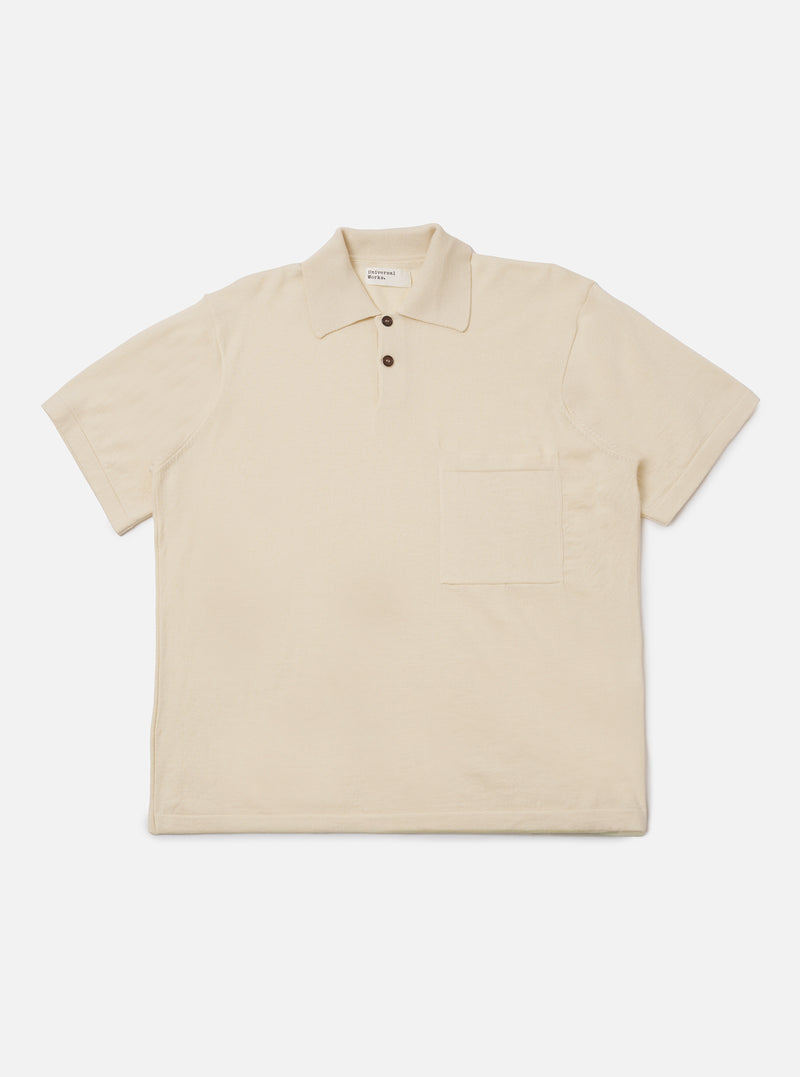 The Ecru Woolcot Bio S/S Pullover Knit Shirt II is shown as a flat lay against a plain white background. This short-sleeved knit shirt features a classic collar, a button placket with two buttons, and a single patch pocket on the left chest. The garment has a boxy fit and is made from a smooth, lightweight ecru-colored knit fabric.