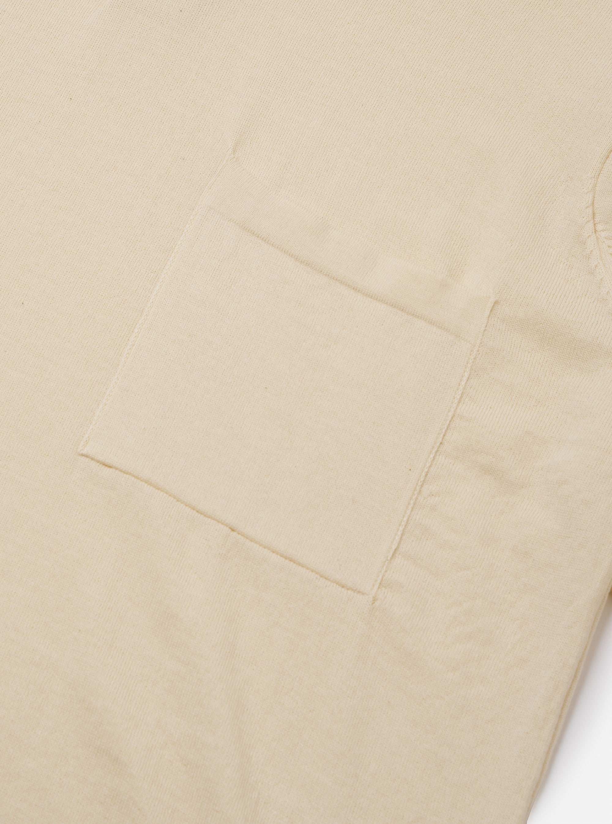 The Ecru Woolcot Bio S/S Pullover Knit Shirt II is shown from the back as a flat lay against a plain white background. The image highlights the simple, clean construction of the garment's rear, the short sleeves, and the soft, textured knit fabric in a solid ecru color.