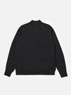 The Black Woolcot Bio Loose Cardigan II is shown from the back as a flat lay against a plain white background. The cardigan features a clean, simple rear design with long sleeves, ribbed cuffs, and a ribbed straight hem. The black knit fabric has a soft, textured appearance.