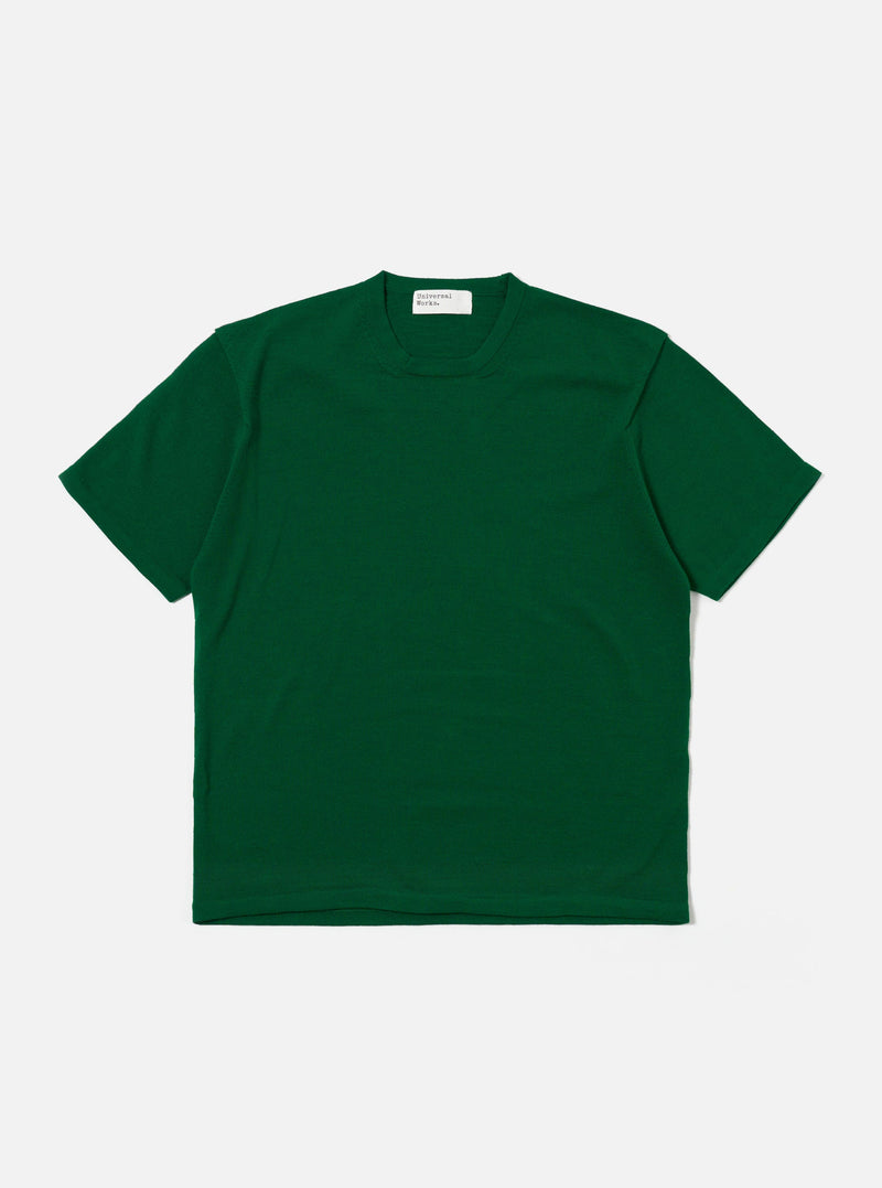 The Green Merino Fine Knit Knit Tee is shown as a flat lay against a white background. The short-sleeved t-shirt features a fine-gauge knit texture with a high crew neck and ribbed detailing at the neckline, cuffs, and hem.