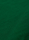 A close-up fabric swatch of the Green Merino Fine Knit Knit Tee highlights the material's fine gauge and soft, textured weave in a solid green color. The image focuses entirely on the fabric detail, and no model or mannequin is present.