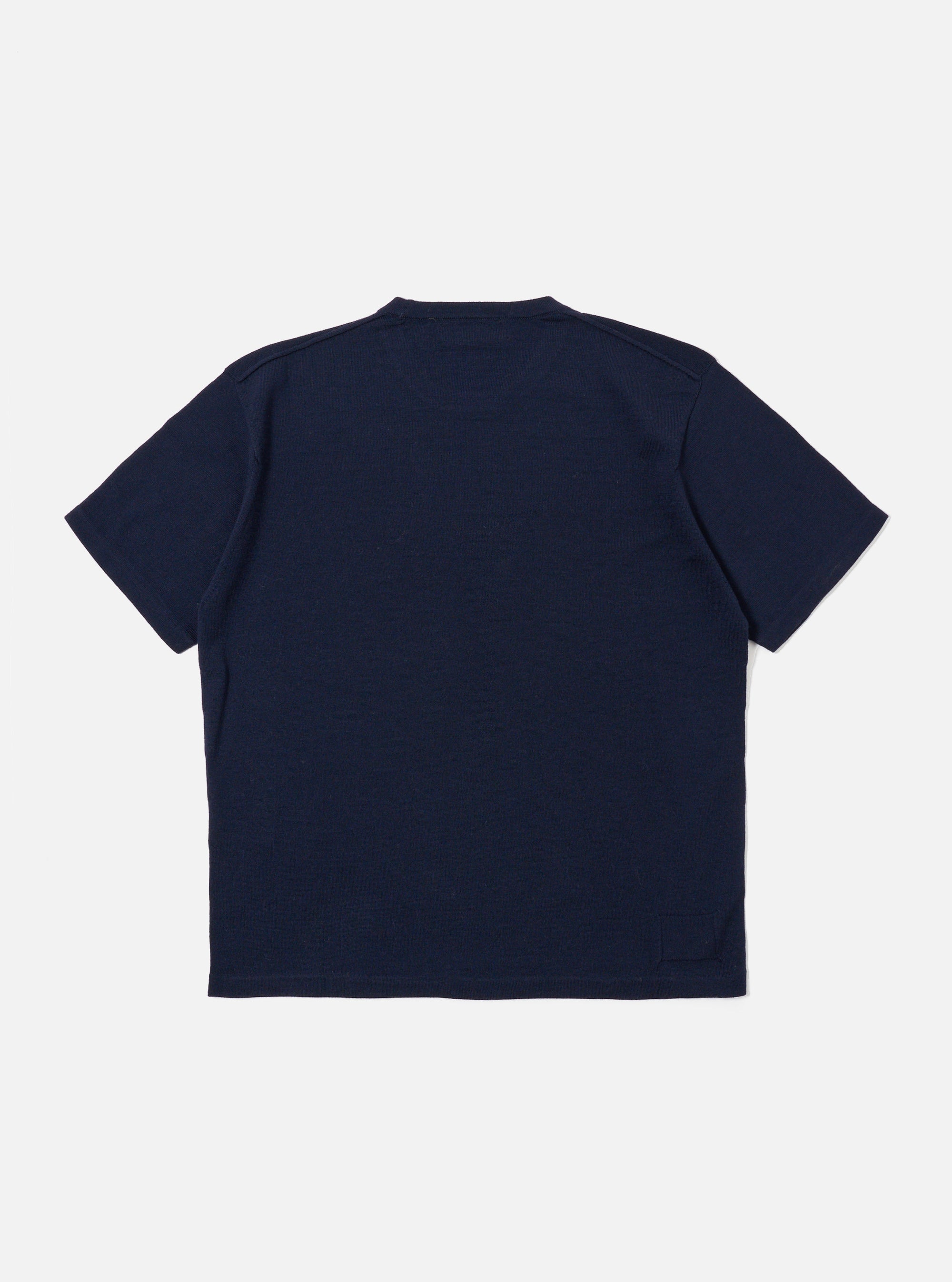 The Navy Merino Fine Knit Knit Tee is shown as a flat lay against a white background. The t-shirt features a fine-ribbed crew neckline, short sleeves, and a straight hem. The knit fabric has a subtle, smooth texture throughout.