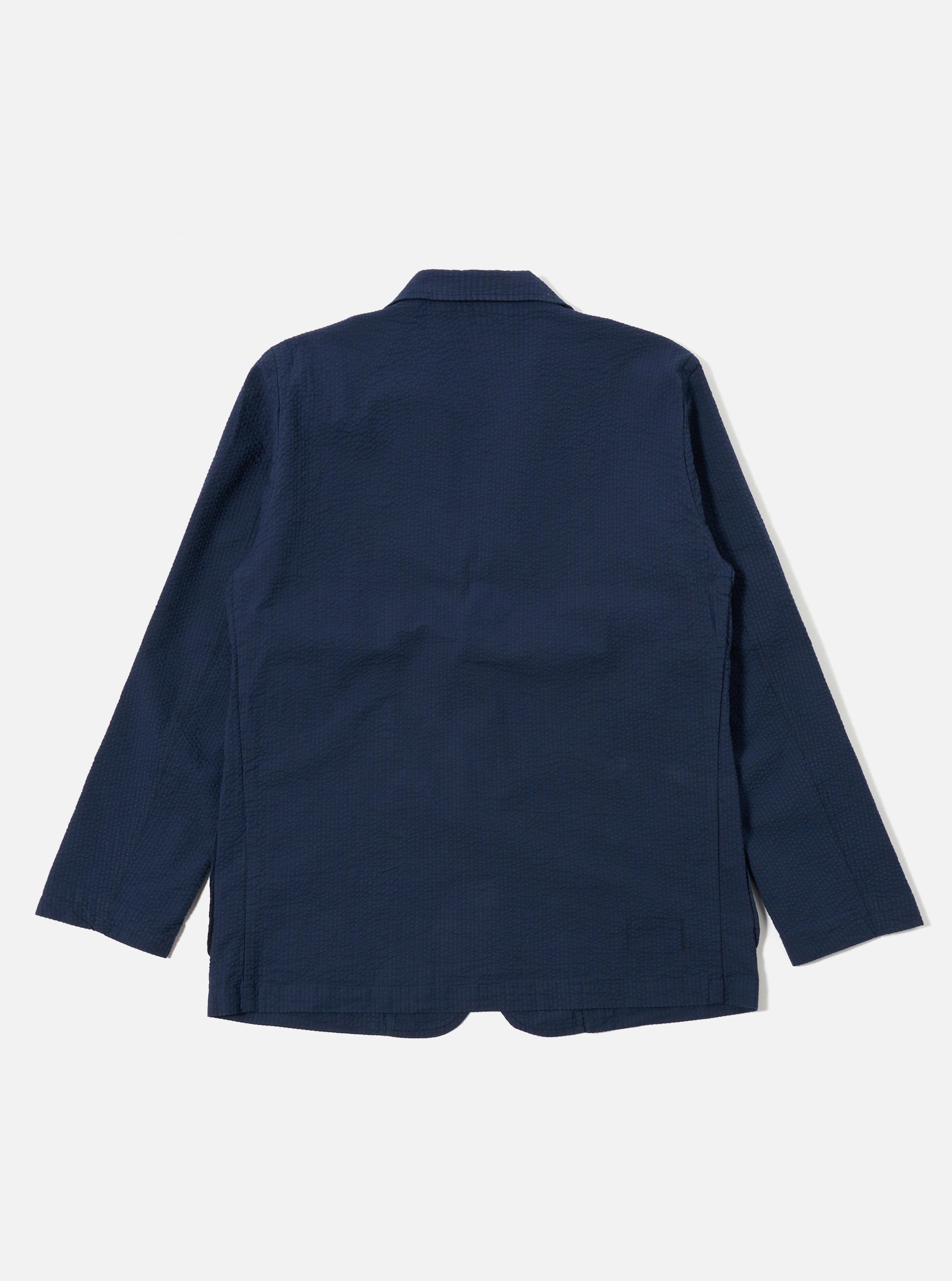 The Navy Derby Stripe Two Button Jacket is displayed as a flat lay from the back against a white background. The image highlights the vertical stripe pattern, the center back seam, and the clean finish of the hem and sleeves.
