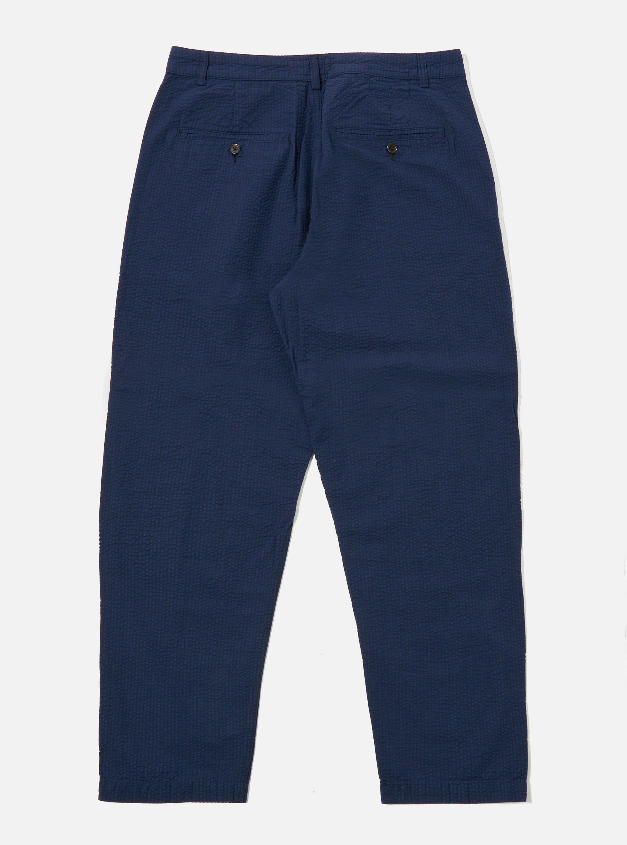 The Navy Derby Stripe Military Chino is shown from the back as a flat lay against a plain white background. The image highlights the two rear pockets and the waistband construction of the trousers. The navy cotton fabric features a visible vertical derby stripe pattern throughout.
