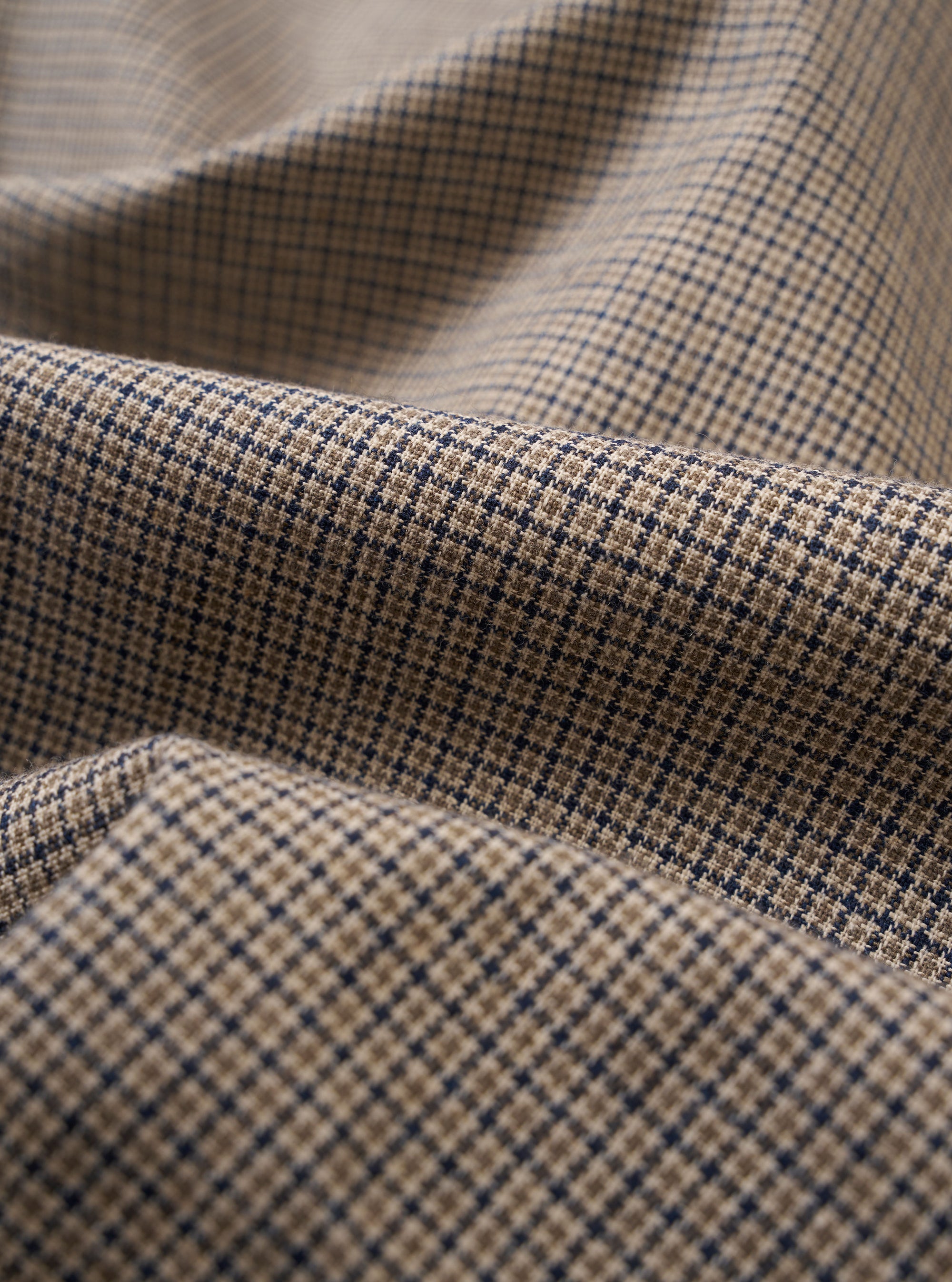 The Multi Lucas Cotton Mix Two Button Jacket is shown in a detail view as a flat lay against a plain white background. The image focuses on the multi-colored check pattern and the textured cotton-linen-acrylic blend fabric. The garment features a longer, wider lapel and visible stitching on the chest patch pocket.