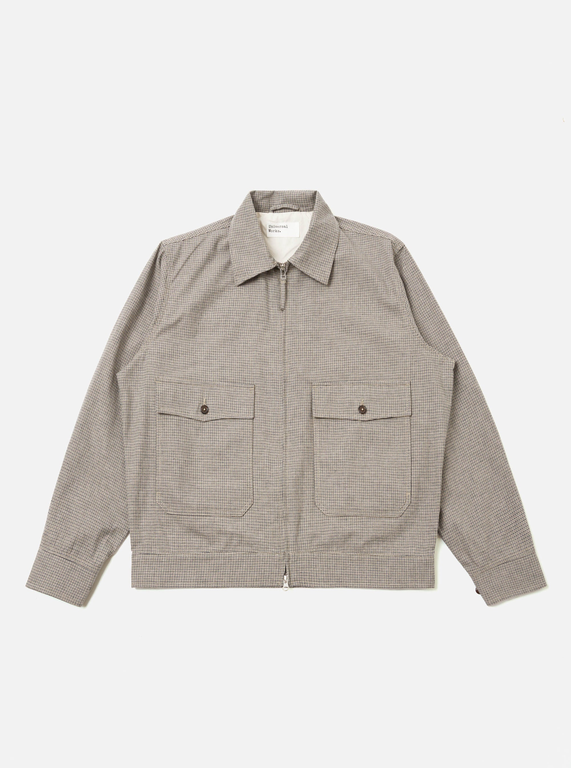 The Multi Lucas Cotton Mix E130 Jacket is shown as a flat lay against a white background. The jacket features a vibrant multi-colored check pattern, a two-way central zip closure, and two large patch pockets at the waist. It has a structured collar and buttoned cuffs.