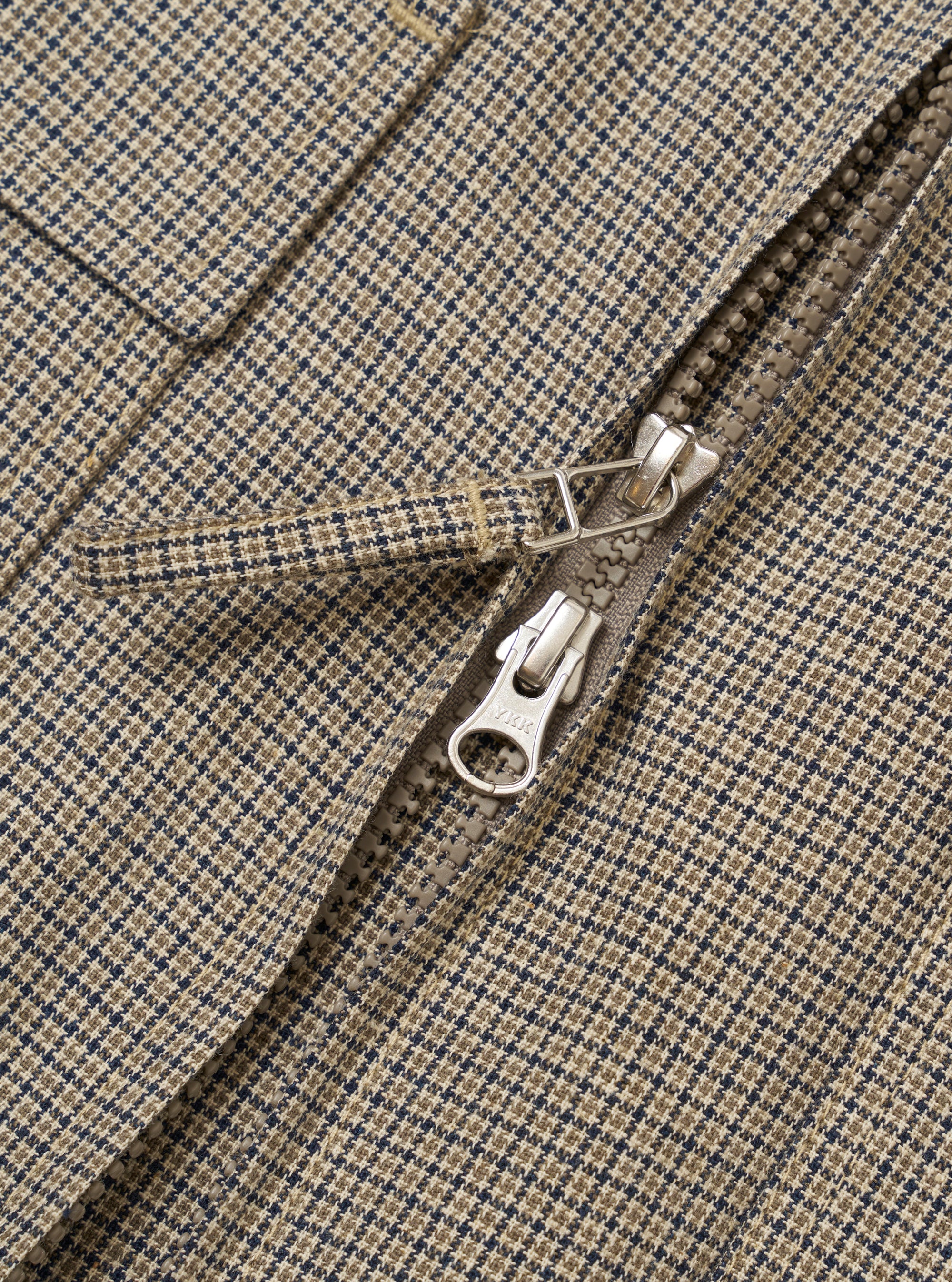 The Multi Lucas Cotton Mix E130 Jacket is shown from the back as a flat lay against a plain white background. The jacket features a vibrant multi-colored check pattern with shades of blue, red, and yellow. Visible details include a straight hem, adjustable button tabs at the waist, and reinforced elbow patches.