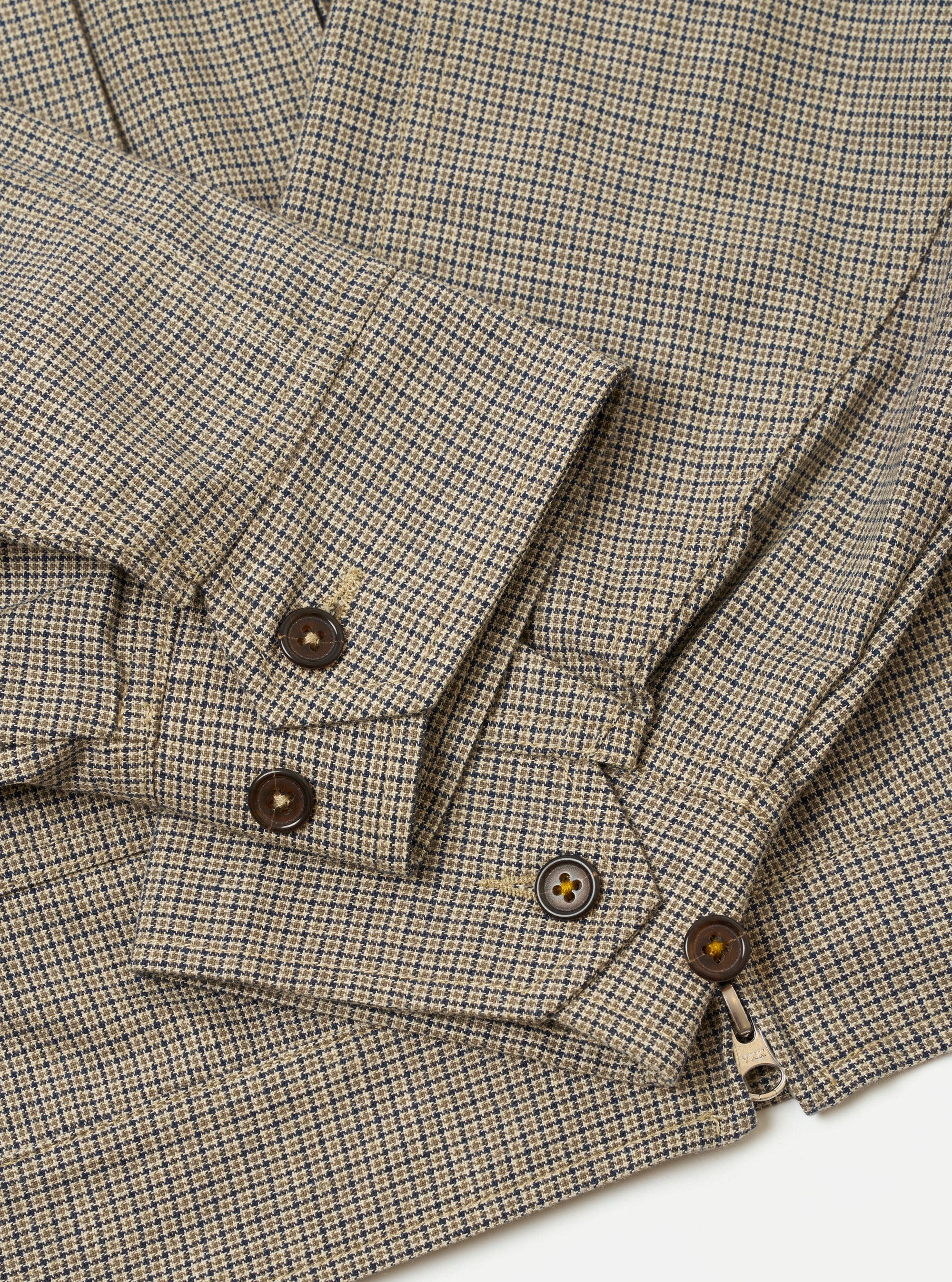 The Multi Lucas Cotton Mix E130 Jacket is shown from the back as a flat lay against a plain white background. The image highlights the colorful check pattern, the straight hem with adjustable waist tabs, and the simple construction of the rear panel including tonal elbow patches.