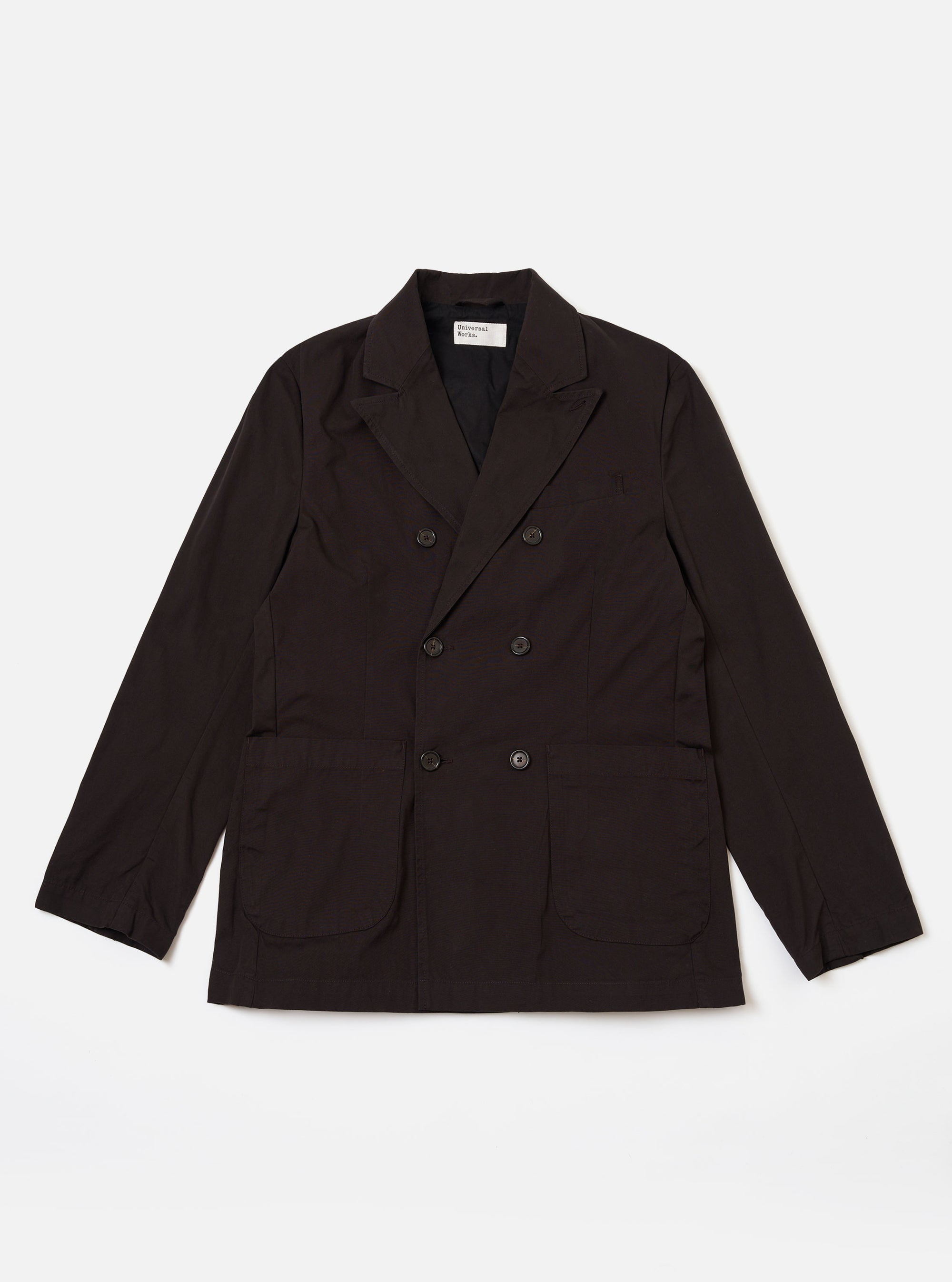 The Licorice Summer Canvas Manor Jacket is shown as a flat lay against a plain white background. The jacket features a three-button front closure, a structured collar with a notched lapel, and three front patch pockets, with one at the chest and two at the waist. The dark brown cotton canvas fabric has a smooth, matte finish.