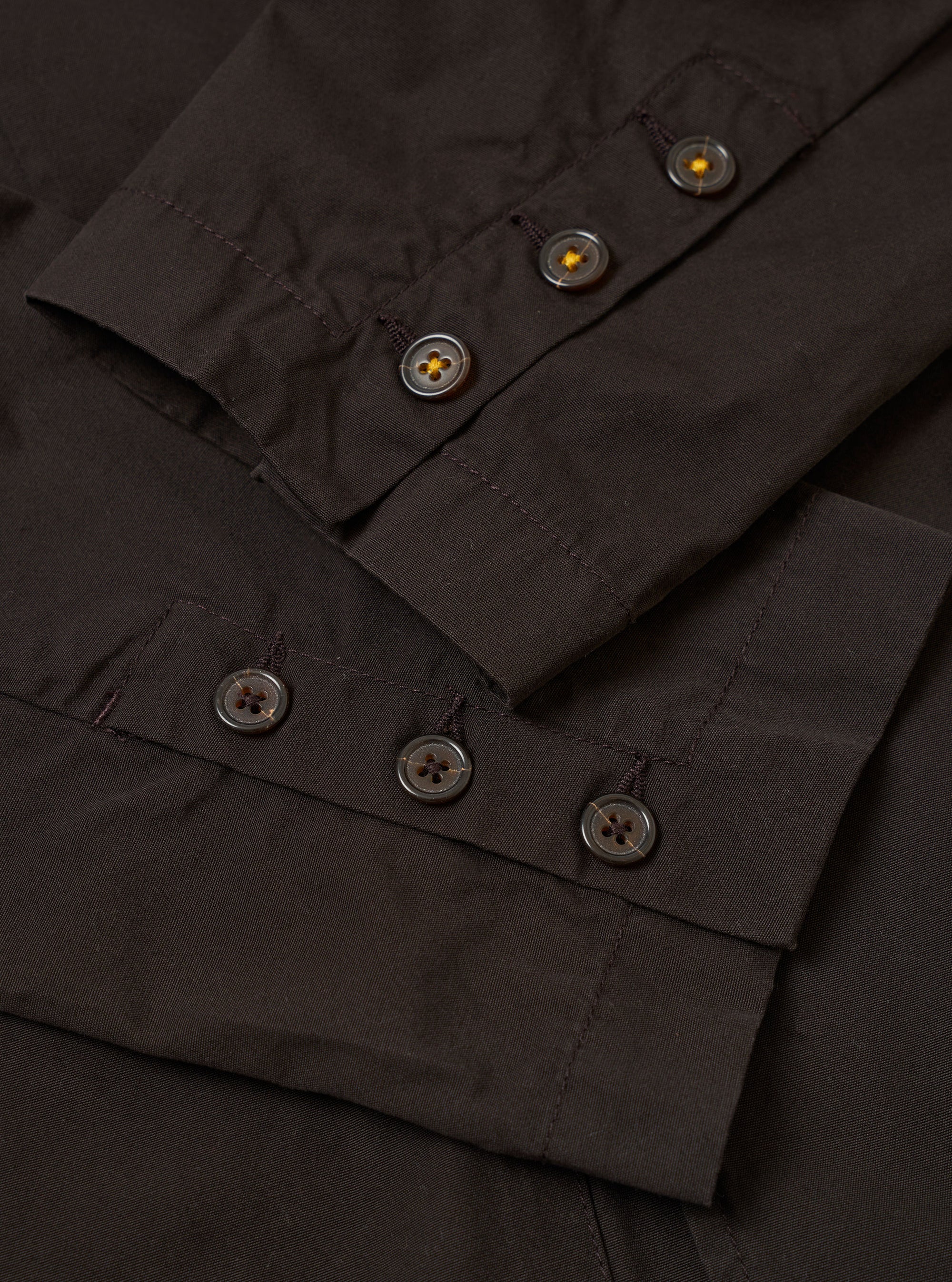 The Licorice Summer Canvas Manor Jacket is shown as a flat lay against a white background. The jacket is a casual, double-breasted blazer with four front buttons, a chest pocket, and two large patch pockets at the waist. The canvas fabric is a dark brown licorice color with a visible textured weave.