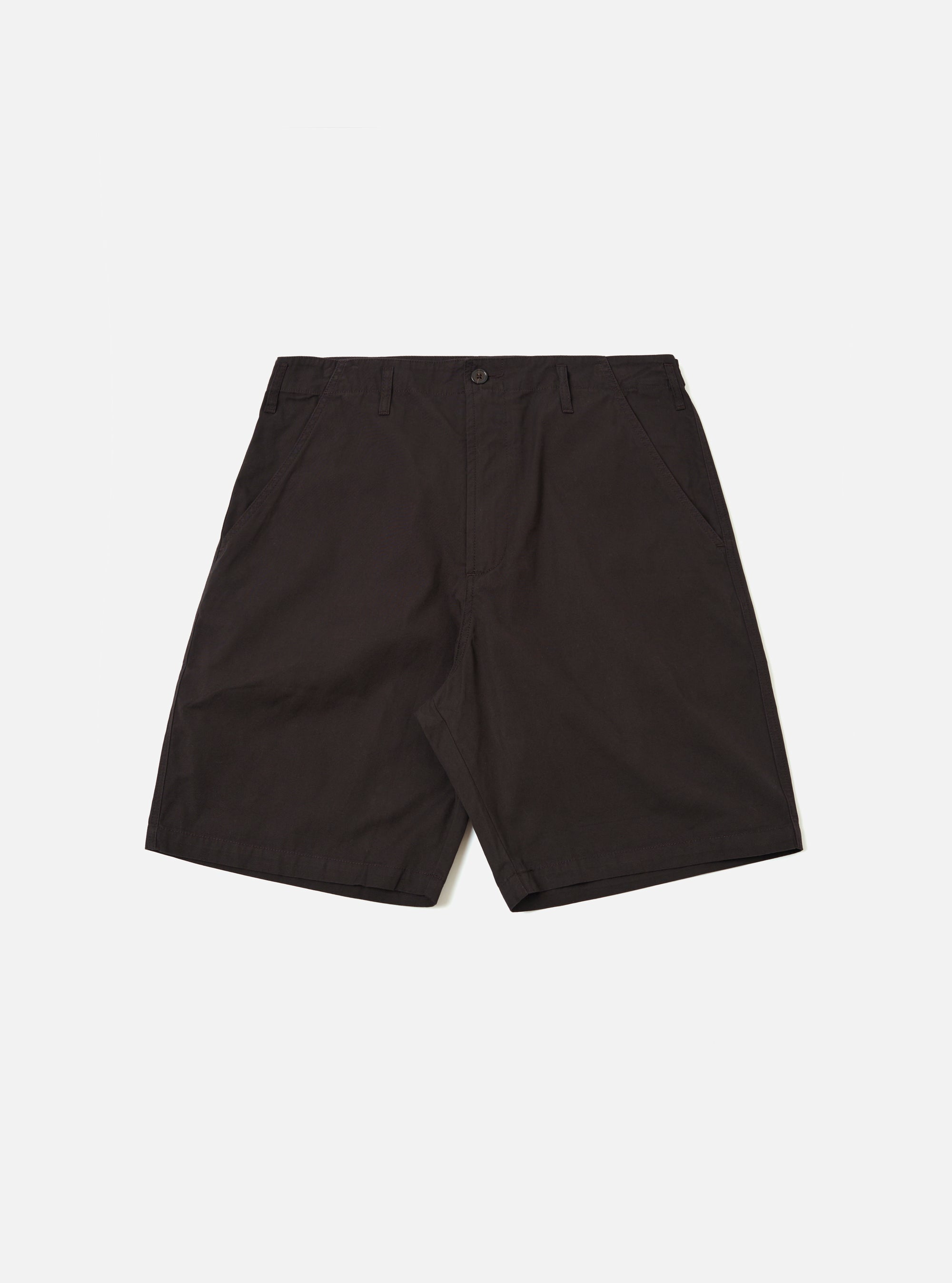 The Licorice Summer Canvas Clean Short is displayed as a flat lay against a plain white background. These dark brown shorts feature a structured waistband with belt loops, a button-front closure, and slanted side pockets. The cotton canvas fabric has a smooth, durable appearance with visible stitching along the seams and hem.