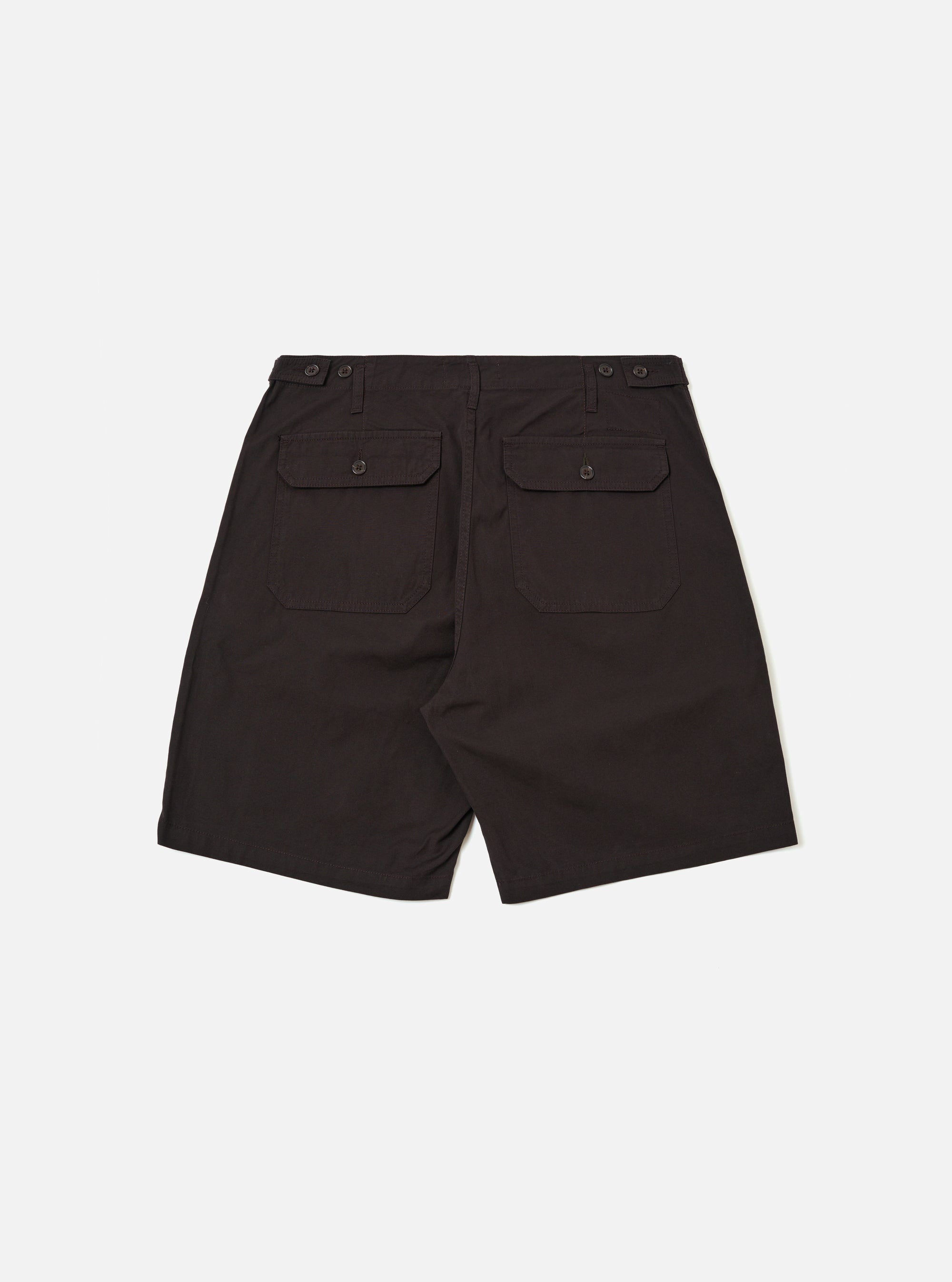 The Licorice Summer Canvas Clean Short is shown from the back as a flat lay against a plain white background. The shorts are a dark brown color and feature a visible elasticated waistband and two large rear patch pockets. The cotton canvas fabric has a smooth, durable appearance with visible stitching details.