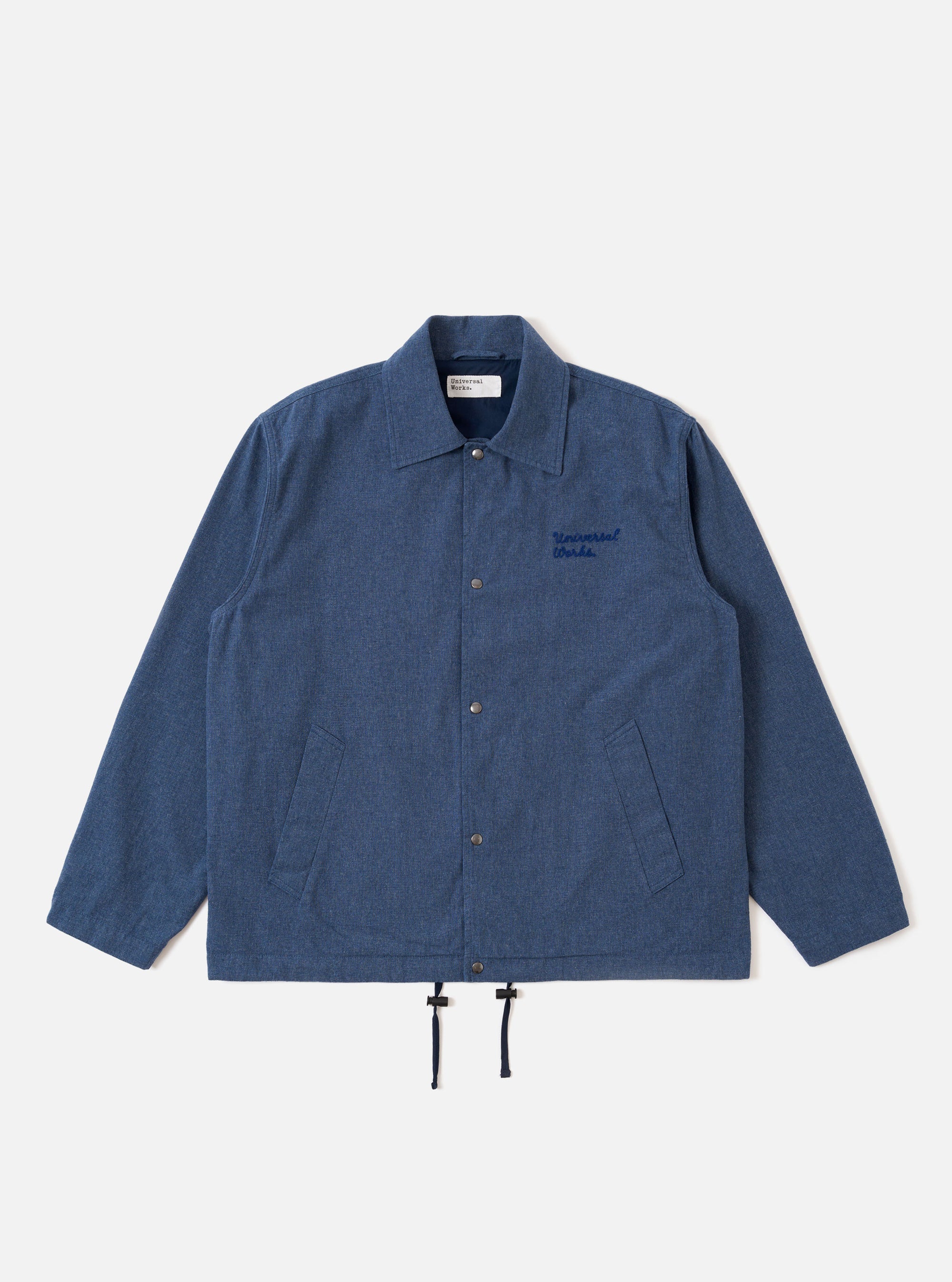 The Blue Sintra Recycled Cotton Head Coach Jacket is shown as a flat lay against a white background. The jacket features a relaxed, boxy fit with a two-way zip front, a classic pointed collar, and two large front patch pockets with button flaps. The blue fabric is a recycled cotton and polyester blend with a smooth, durable finish.