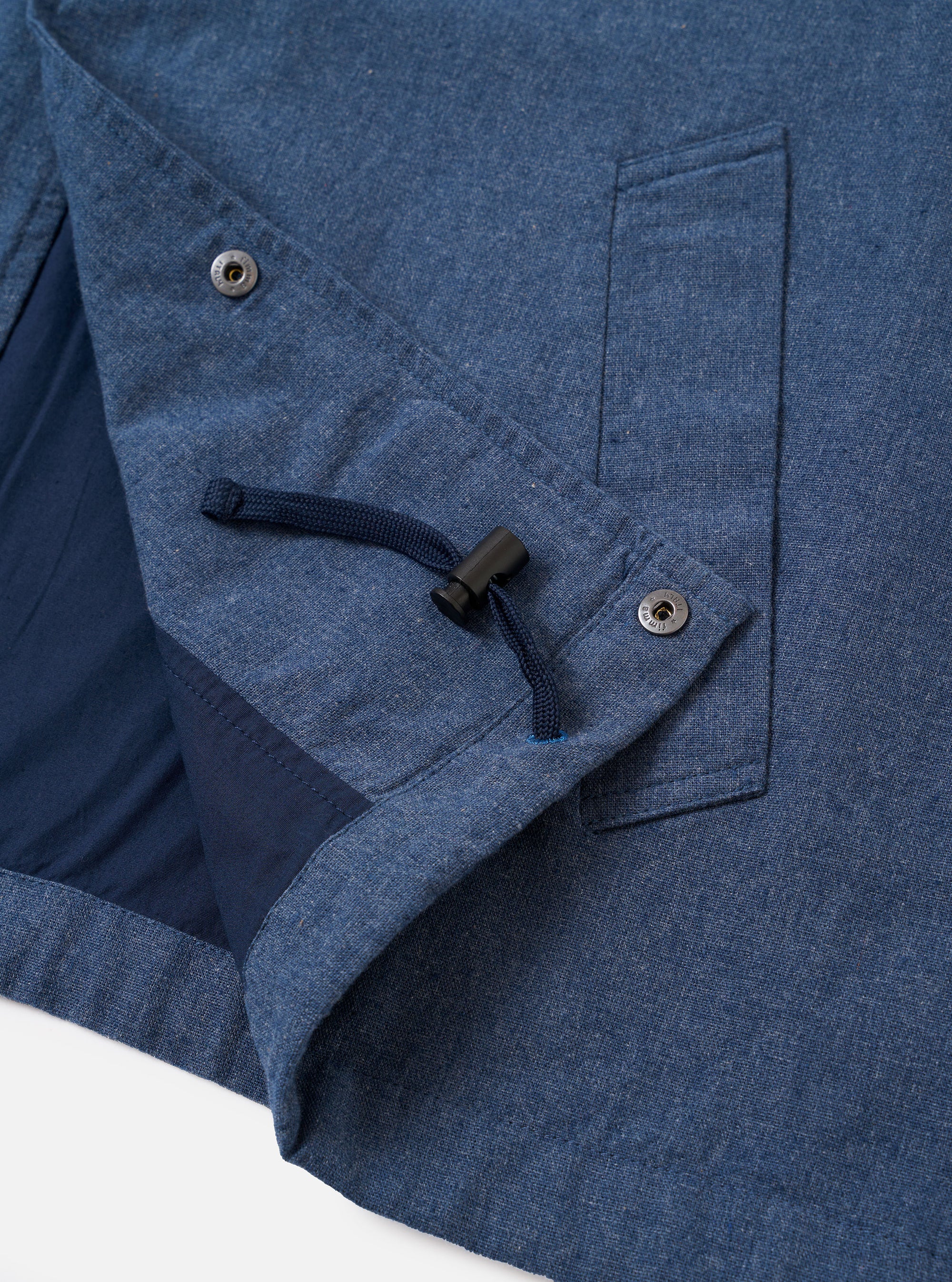 The Blue Sintra Recycled Cotton Head Coach Jacket is shown from the back as a flat lay against a plain white background. The image highlights the jacket's simple, straight-cut rear panel, a classic collar, and tonal stitching along the hem and sleeves. The blue fabric has a smooth, uniform texture.