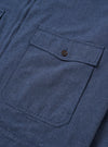 The Blue Sintra Recycled Cotton E130 Jacket is shown from the back as a flat lay against a plain white background. The image highlights the clean, simple construction of the garment's rear, featuring a straight hem and a standard pointed collar. The recycled cotton fabric is a solid, mid-blue color with a smooth texture.