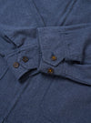 The Blue Sintra Recycled Cotton E130 Jacket is shown from the back as a flat lay against a plain white background. The image highlights the clean, simple construction of the garment's rear, the straight hem, and the smooth blue recycled cotton fabric.