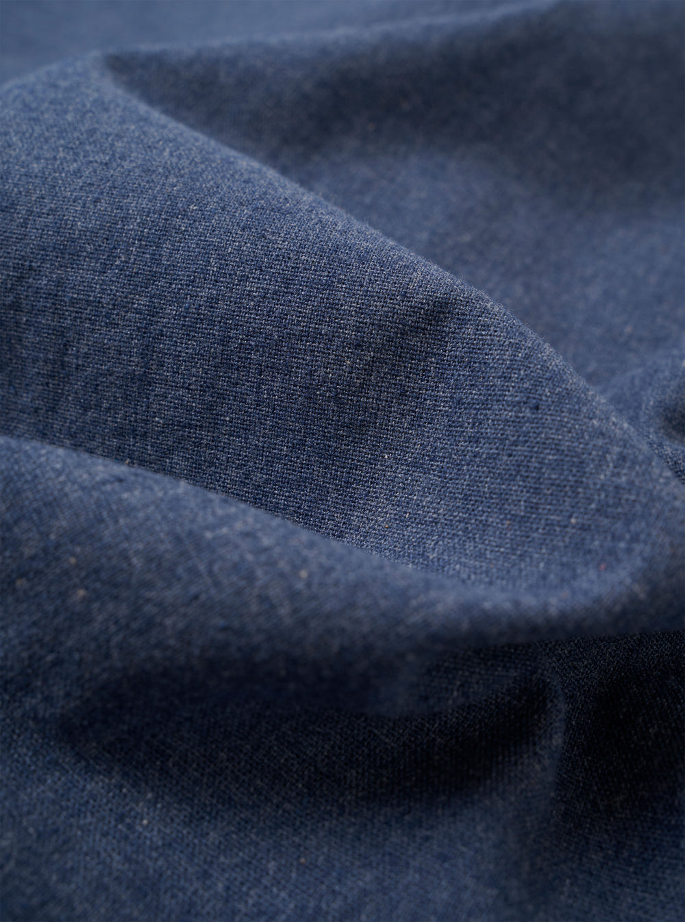 The Blue Sintra Recycled Cotton E130 Jacket is displayed as a flat lay against a plain white background. The jacket features a standard collar, a central button closure, and two large patch pockets at the waist. The fabric is a solid blue recycled cotton blend with a smooth texture.