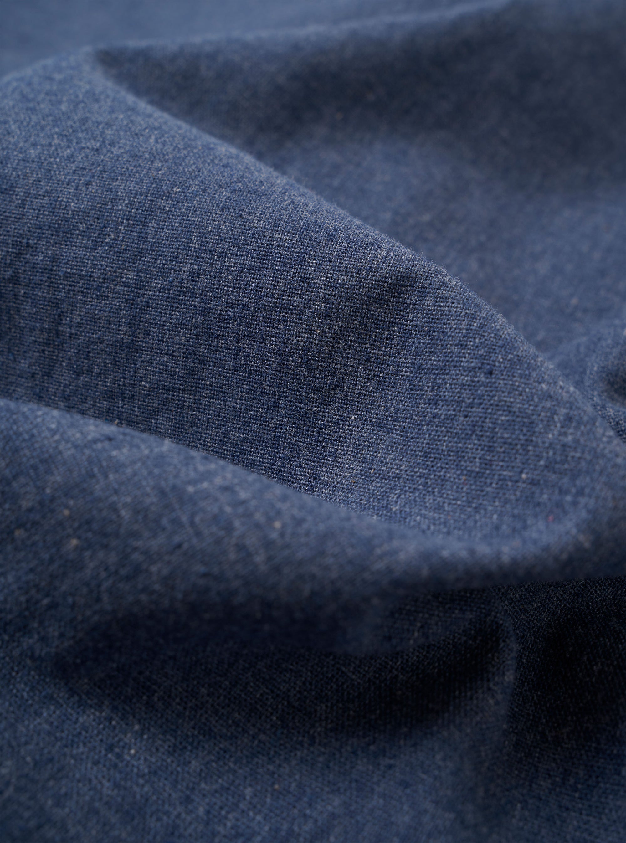 The Blue Sintra Recycled Cotton E130 Jacket is displayed as a flat lay against a plain white background. The jacket features a standard collar, a central button closure, and two large patch pockets at the waist. The fabric is a solid blue recycled cotton blend with a smooth texture.