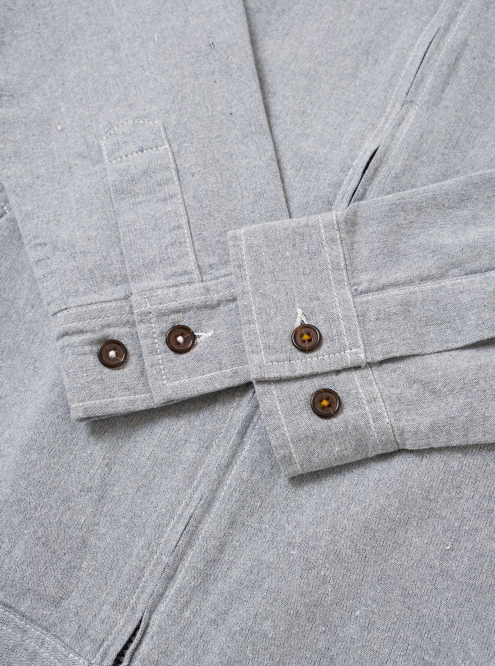 The Light Indigo Jean Cloth Reworked Rose Bowl Jacket is shown from the back as a flat lay against a plain white background. The jacket is constructed from light indigo organic cotton and features a clean, simple back panel with a straight hem and visible tonal stitching along the seams.