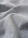 A close-up fabric swatch of the Light Indigo Jean Cloth Reworked Rose Bowl Jacket highlights the light indigo blue color and the textured weave of the reworked jean cloth material.