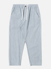 The Light Indigo Jean Cloth Reworked Hi Water Trouser is shown as a flat lay against a white background. The trousers feature a drawstring waist, two slanted front pockets, and a slightly cropped, loose fit. The fabric is a light indigo organic cotton with a visible textured weave.
