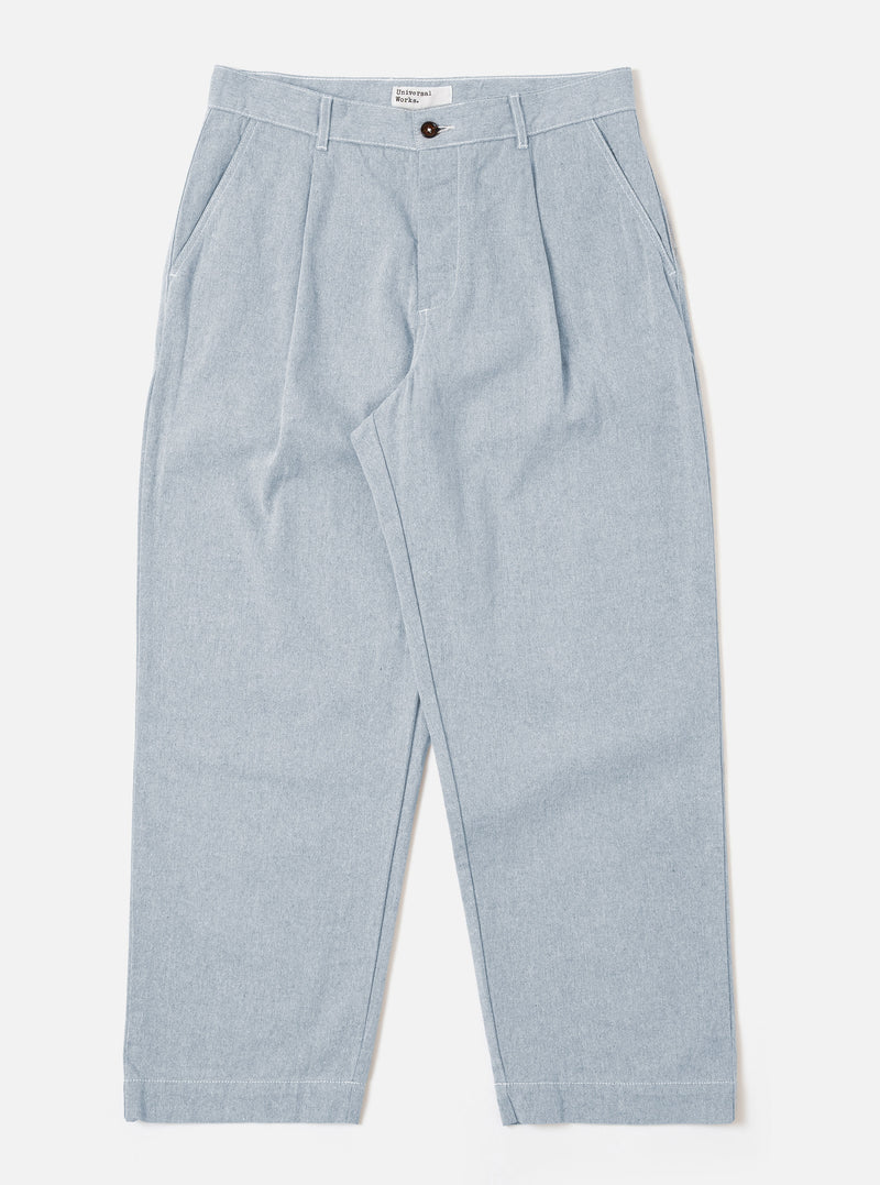 The Light Indigo Jean Cloth Reworked Duke Pant is shown as a flat lay against a plain white background. The trousers feature a wide-leg fit, a single pleat at the front, and a button-front closure with a fixed waistband. The light indigo organic cotton fabric has a textured appearance.
