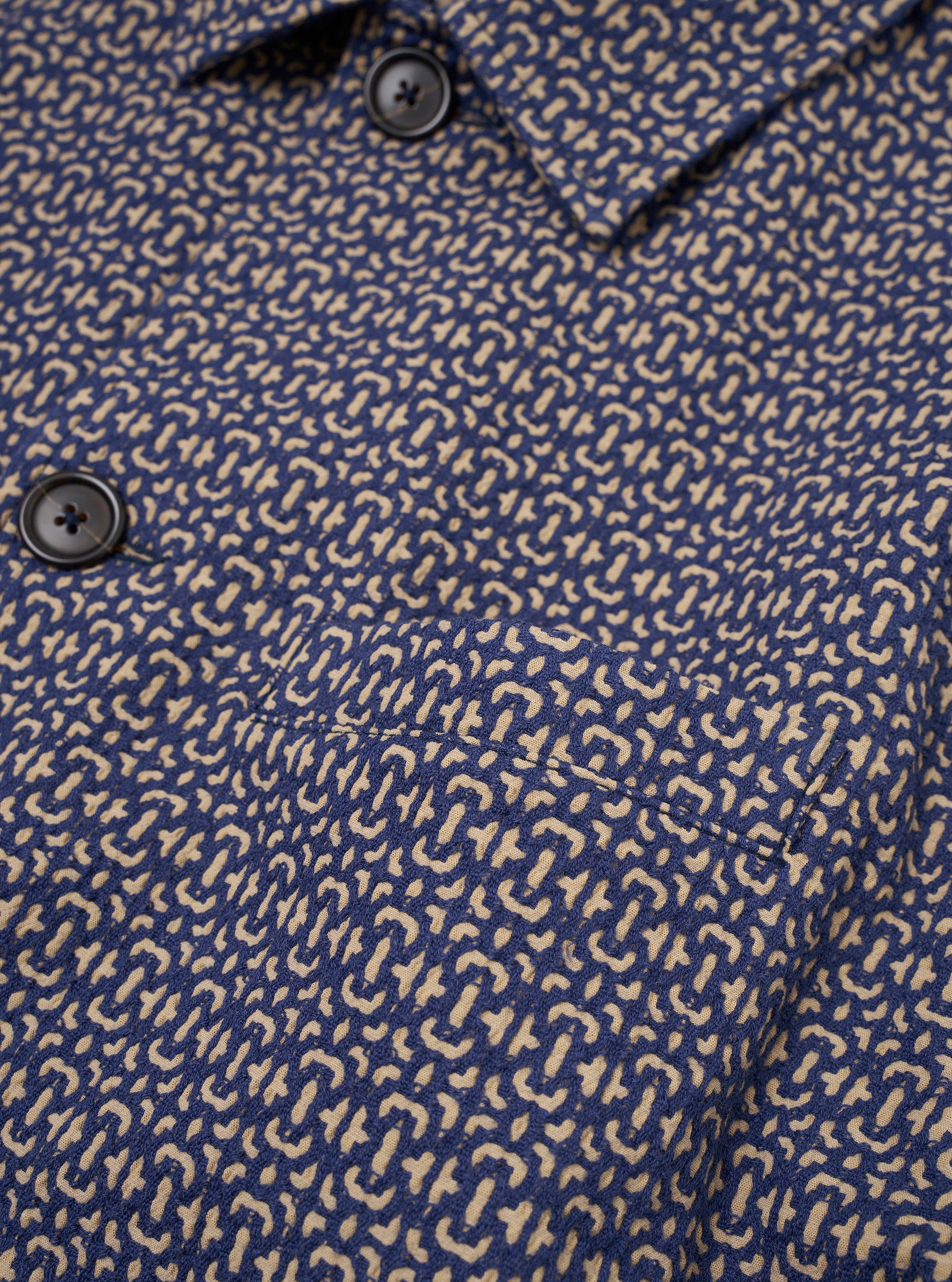 The Navy Konos Cotton Warmus Jacket is shown from the back as a flat lay against a plain white background. The image highlights the clean, simple construction of the garment's rear panel, the straight hem, and the textured navy blue cotton fabric.