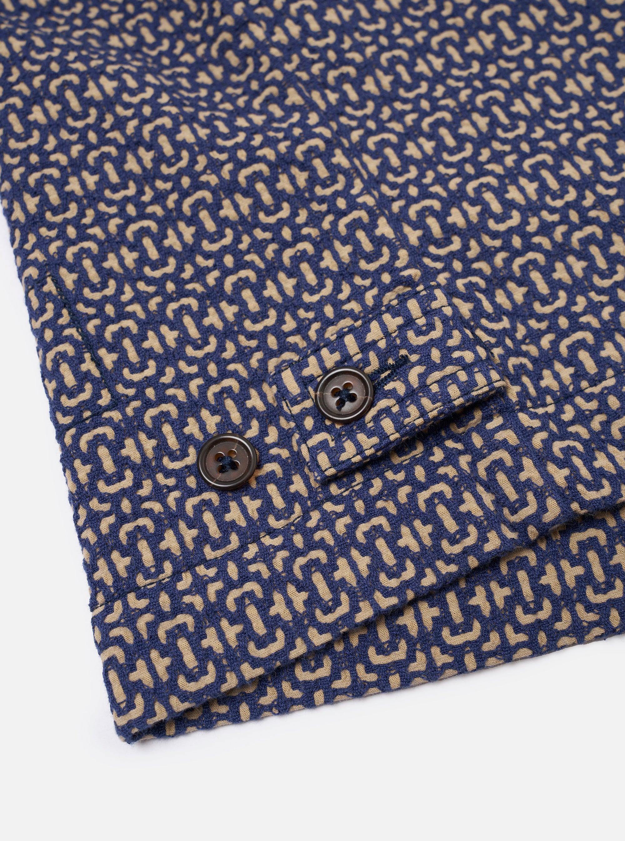 The Navy Konos Cotton Warmus Jacket is shown from the back as a flat lay against a plain white background. The image highlights the clean, simple construction of the garment's rear panel and the adjustable button-down straps at the sides of the bottom hem.