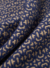 A close-up fabric swatch of the Navy Konos Cotton Warmus Jacket highlights the deep navy blue color and the distinct texture of the cotton fabric. The material fills the frame, providing a detailed view of the garment's weave and color.