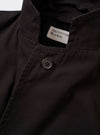 The Licorice Summer Canvas Two Button Jacket is displayed as a flat lay against a solid white background. The brown jacket features a notched lapel, a two-button front closure, and three patch pockets, including one on the chest and two larger ones at the waist. The cotton canvas fabric has a visible weave and structured appearance.