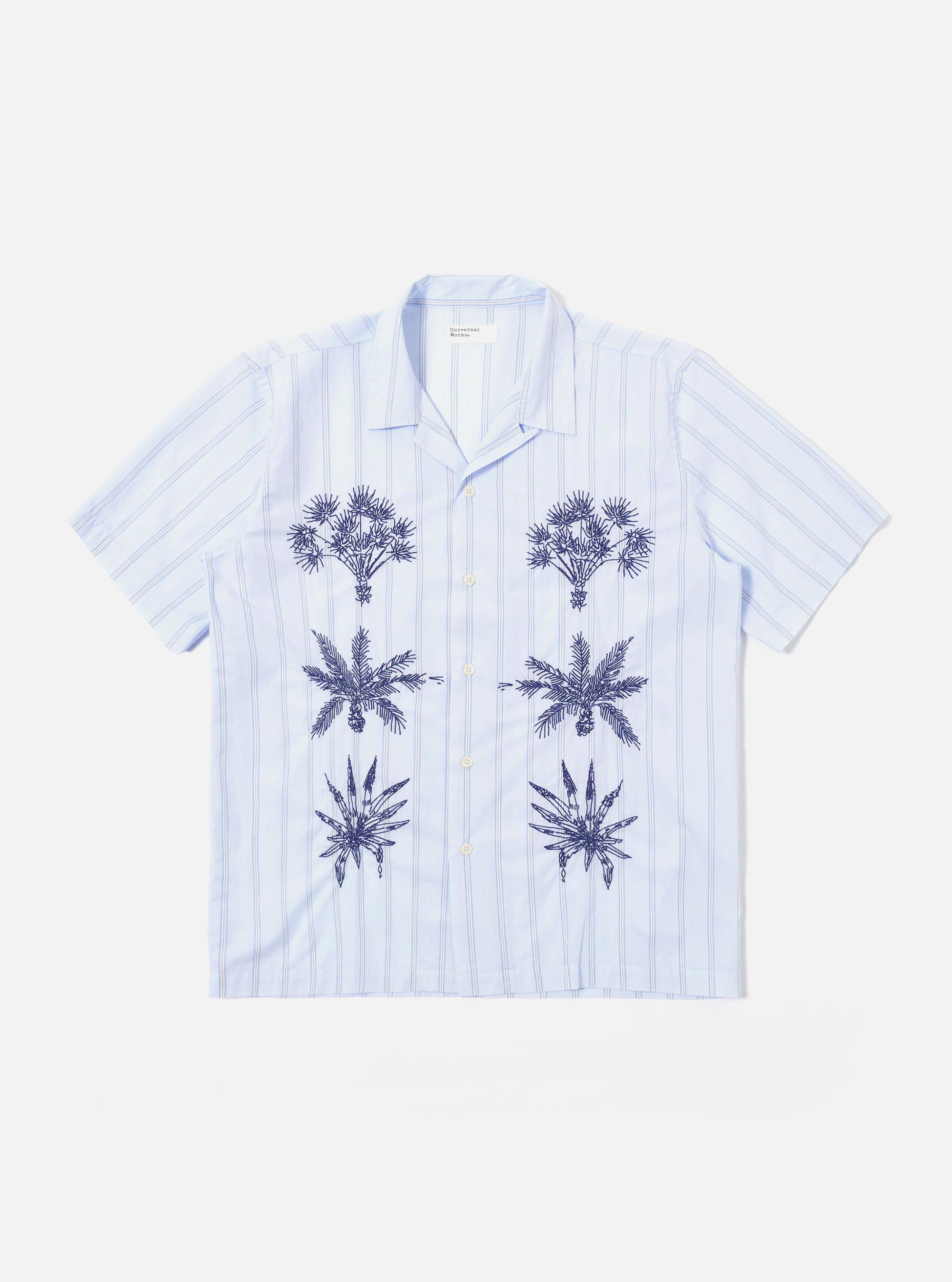 The Soft Blue Mc Stripe Road Trip Shirt is displayed as a flat lay against a plain white background. The shirt features a camp collar, a chest patch pocket, and a full button-down front. The fabric has a distinctive vertical stripe pattern in shades of blue and white.
