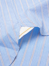 The Blue Mc Stripe Square Pocket Shirt is shown from the back as a flat lay against a plain white background. The image highlights the clean construction of the shirt, featuring a structured back yoke and a curved hem. The blue and white vertical stripe pattern is visible across the cotton fabric.