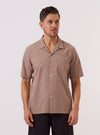 The Brown Sido Linen Mix Road Shirt is worn by a model against a plain white background. The shirt features a camp collar, a single chest patch pocket, and a button-down front. It is shown in a full-length front view, highlighting its relaxed fit and textured linen-blend fabric.