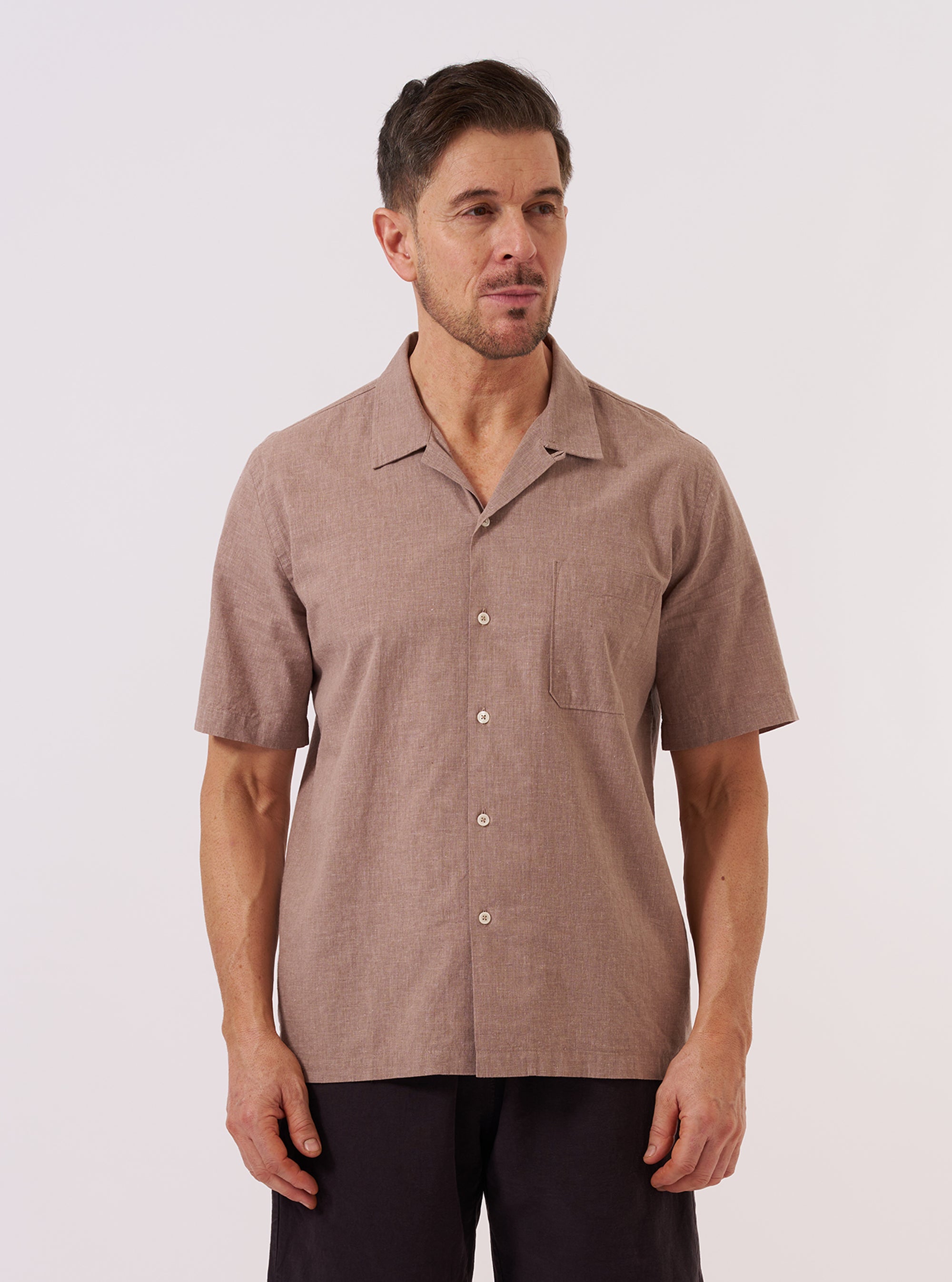 The Brown Sido Linen Mix Road Shirt is worn by a model against a plain white background. The shirt features a camp collar, a single chest patch pocket, and a button-down front. It is shown in a full-length front view, highlighting its relaxed fit and textured linen-blend fabric.