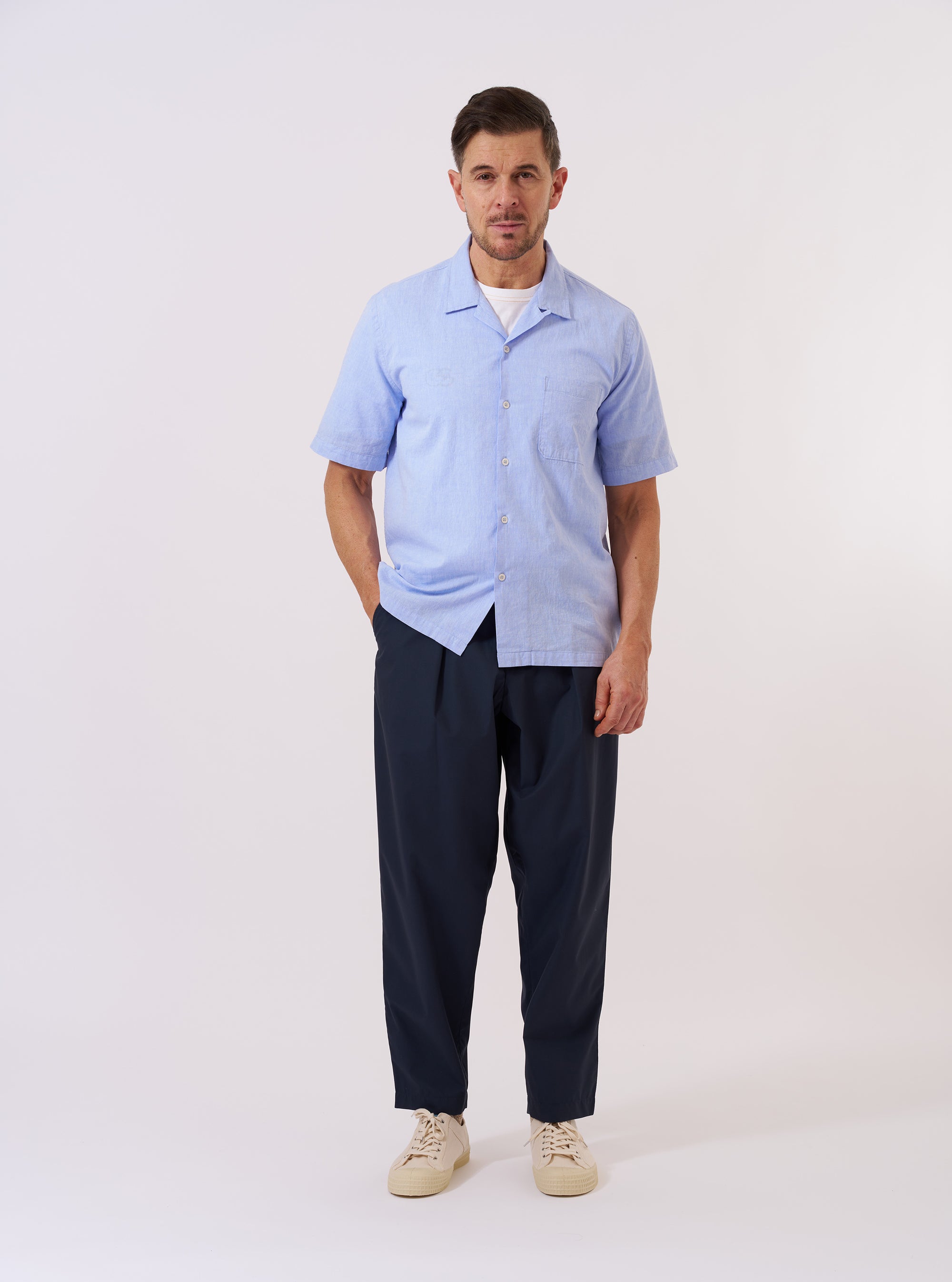 The Sky Blue Sido Linen Mix Road Shirt is shown as a flat lay against a plain white background. The shirt features a relaxed camp collar, a single chest patch pocket, and a central button-down front. The garment is made from a light sky blue linen-blend fabric with a subtle textured weave.