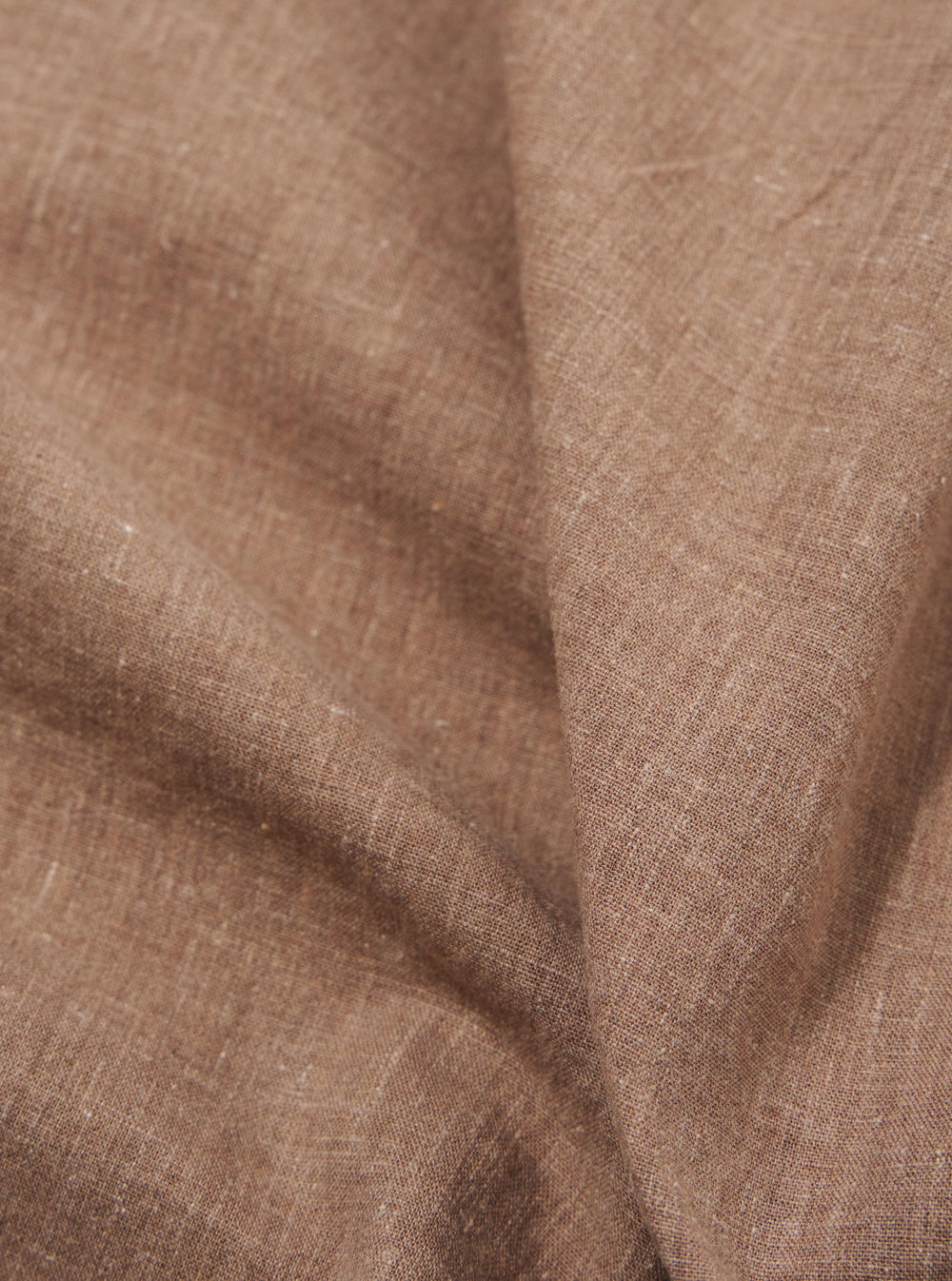 A close-up fabric swatch of the Brown Sido Linen Mix Road Shirt highlights the textured weave and rich brown color. The image focuses on the material's interlacing threads, showing the blend of linen and cotton. No model or mannequin is present.