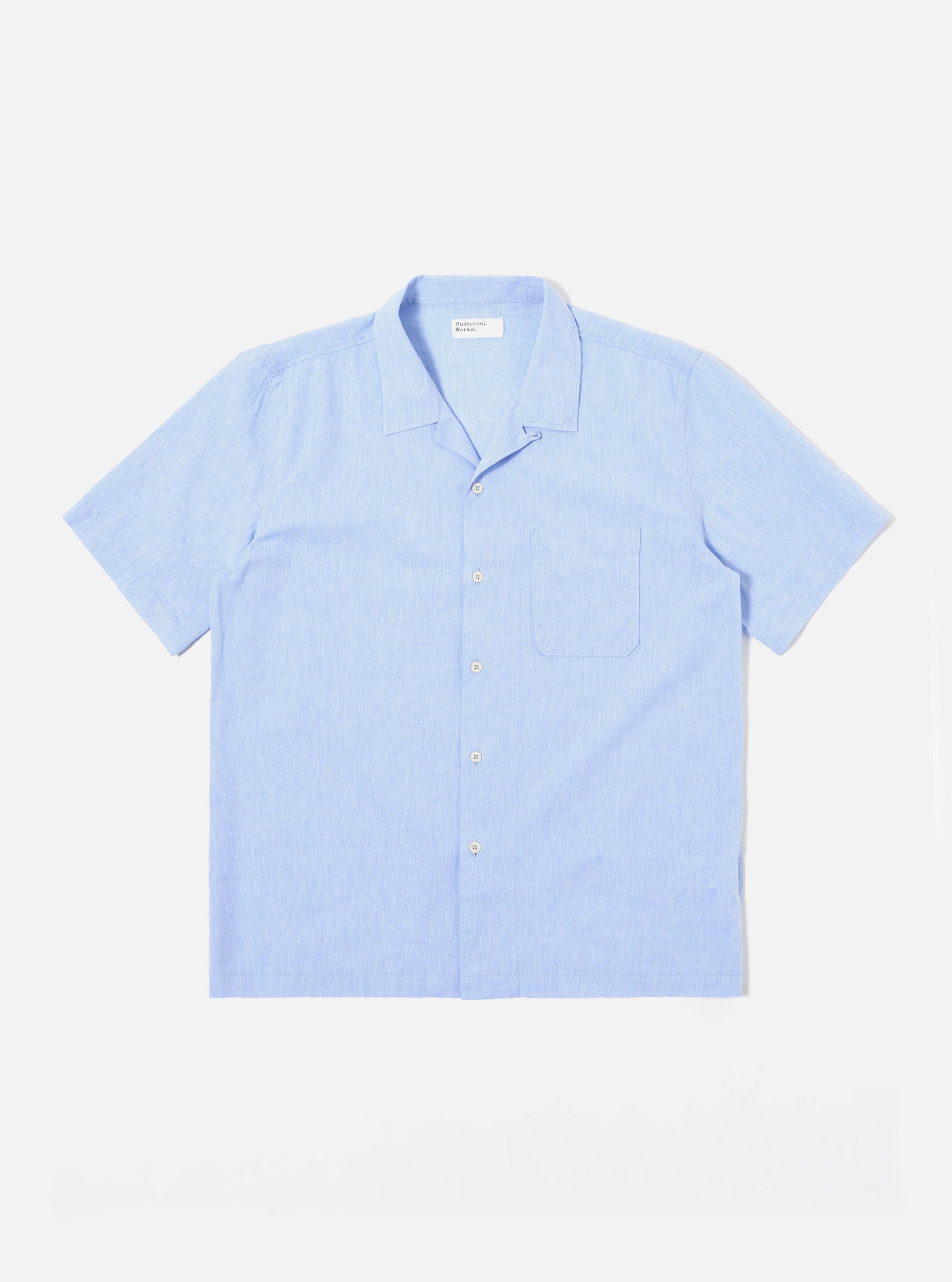 The Sky Blue Sido Linen Mix Road Shirt is shown as a flat lay against a plain white background. The shirt features a camp collar, a central button-down front with tonal buttons, and a single patch pocket on the left chest. The fabric is a lightweight sky blue cotton-linen blend with a subtle texture.