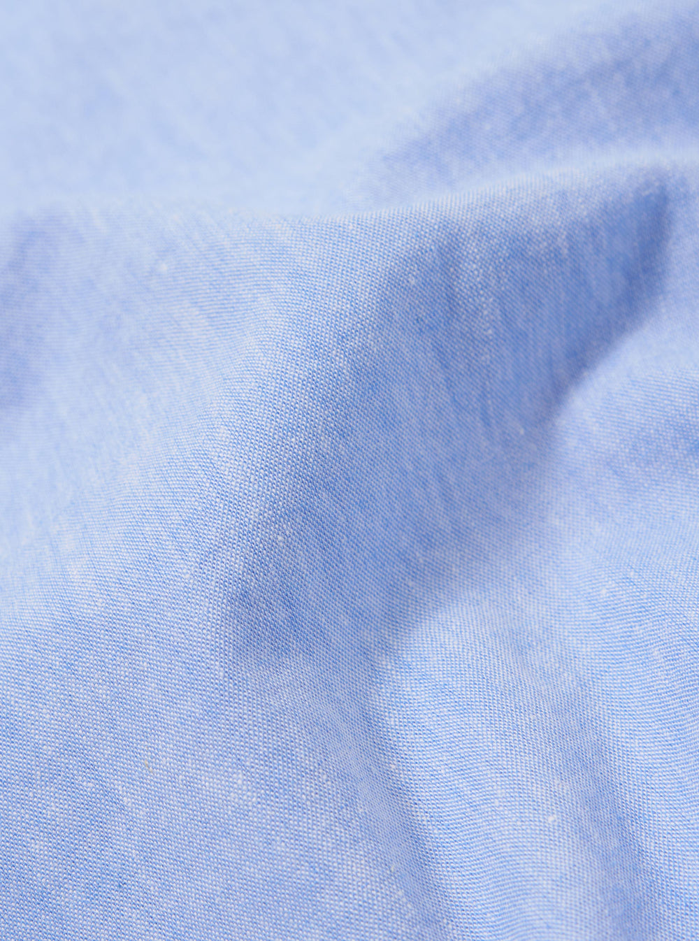A close-up fabric swatch of the Sky Blue Sido Linen Mix Road Shirt is shown, highlighting the soft sky blue color and the subtle, textured weave of the cotton-linen blend.