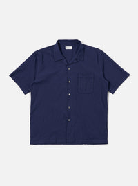 The Navy Arten Seersucker Road Shirt is shown as a flat lay against a white background. The short-sleeved shirt features a camp collar with a loop closure, a single chest patch pocket, and a straight hem. The dark navy fabric has a distinct puckered seersucker texture throughout.
