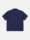 The Navy Arten Seersucker Road Shirt is shown from the back as a flat lay against a plain white background. The image highlights the garment's straight hem and the distinct puckered texture of the navy blue seersucker fabric.