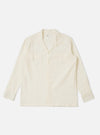 The Ecru Arten Seersucker Attendant Shirt is shown as a flat lay against a plain white background. The shirt features a button-through front, two chest patch pockets with flaps, and a structured collar. The ecru fabric has a distinct puckered seersucker texture.