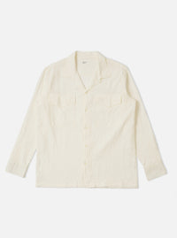 The Ecru Arten Seersucker Attendant Shirt is shown as a flat lay against a plain white background. The shirt features a button-through front, two chest patch pockets with flaps, and a structured collar. The ecru fabric has a distinct puckered seersucker texture.