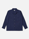 The Navy Arten Seersucker Attendant Shirt is shown as a flat lay against a white background. The shirt features a central button-down front, a classic collar, and two large patch pockets at the waist. The dark navy fabric has a distinct puckered seersucker texture.