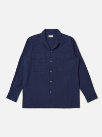 The Navy Arten Seersucker Attendant Shirt is shown as a flat lay against a white background. The shirt features a central button-down front, a classic collar, and two large patch pockets at the waist. The dark navy fabric has a distinct puckered seersucker texture.
