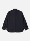 The Navy Tropical Suiting Travail Overshirt is shown from the back as a flat lay against a plain white background. The image highlights the clean construction of the garment's rear panel, featuring a simple one-piece collar, straight-cut yoke, and a curved hemline. The dark navy fabric has a smooth, lightweight tropical wool appearance.