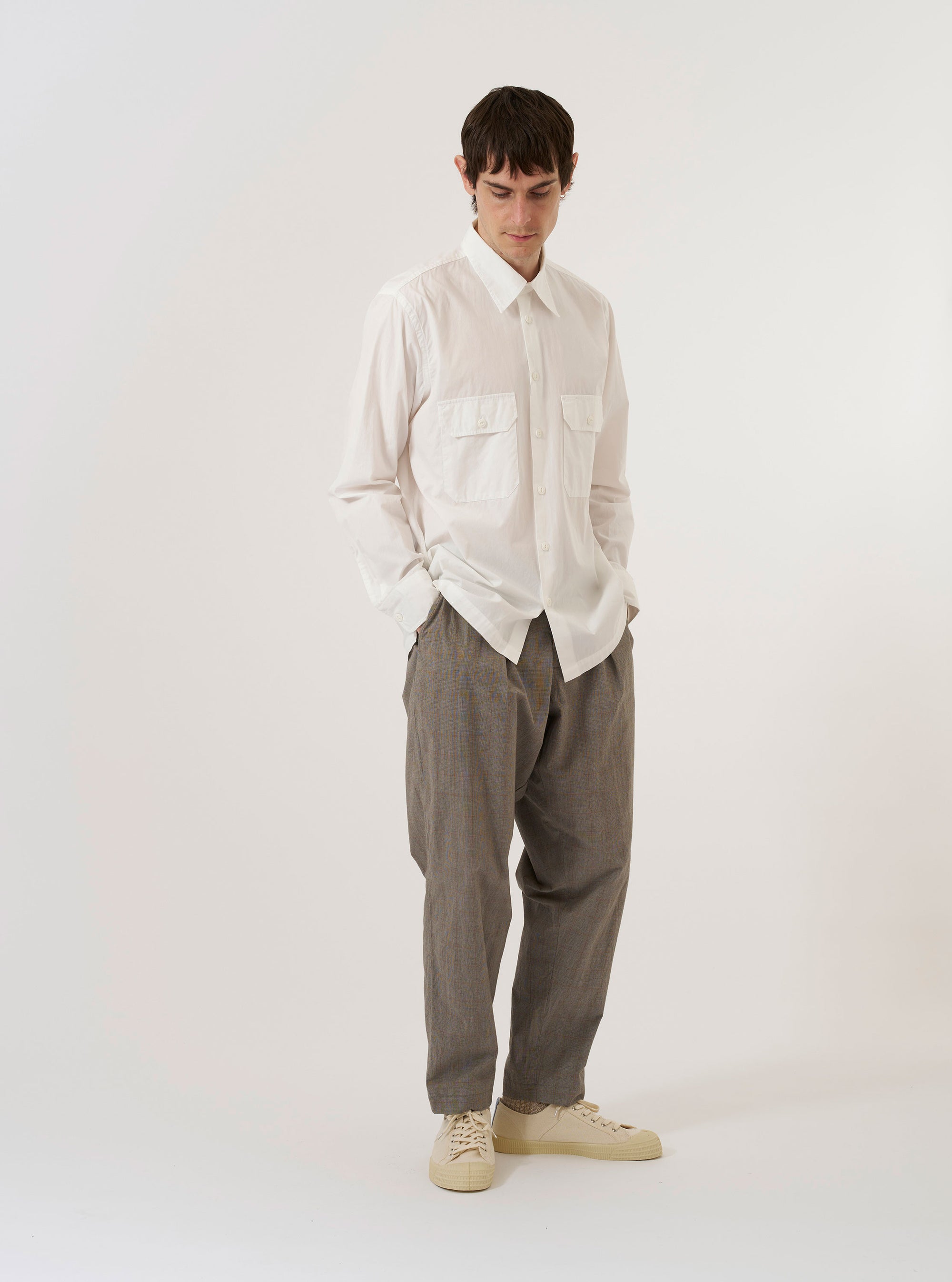 The Ecru Organic Fine Poplin CPO Shirt is shown as a flat lay against a plain white background. The shirt features a relaxed fit with a two-piece collar, a central button-down front, and two large buttoned patch pockets at the chest. The organic cotton poplin fabric is a solid ecru color with a crisp texture, and the garment is finished with a straight hem and functional buttoned cuffs.