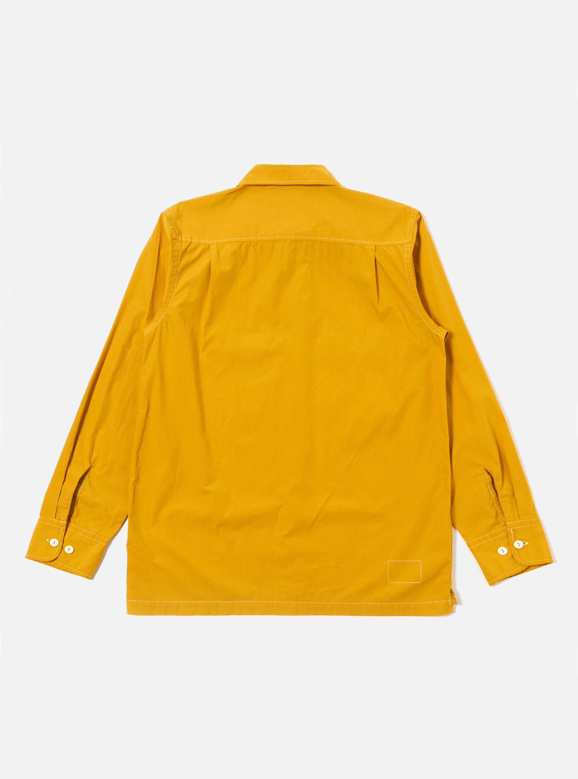 The Golden Brown Organic Fine Poplin CPO Shirt is shown from the back as a flat lay against a plain white background. The image highlights the shirt's smooth golden brown fabric, a straight hem, and a simple back yoke with a central box pleat.